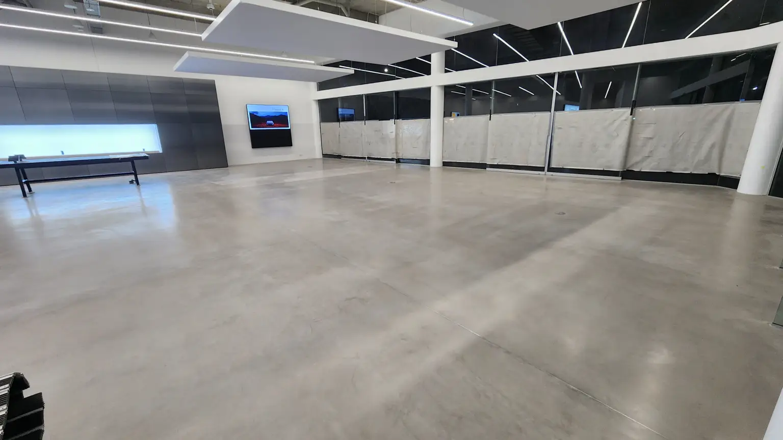 Epoxy showroom flooring at Polestar Artarmon with high-gloss seamless finish