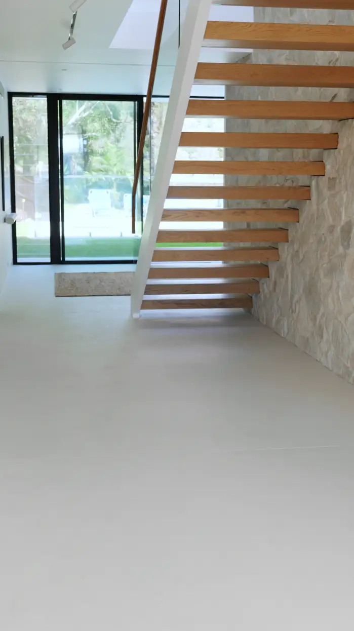 Seamless microcement surface in a styled, light-filled Avalon living space