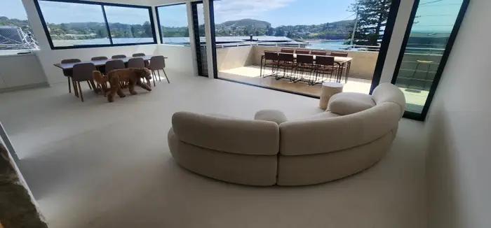 Warm, pale microcement floor finish in an Avalon home