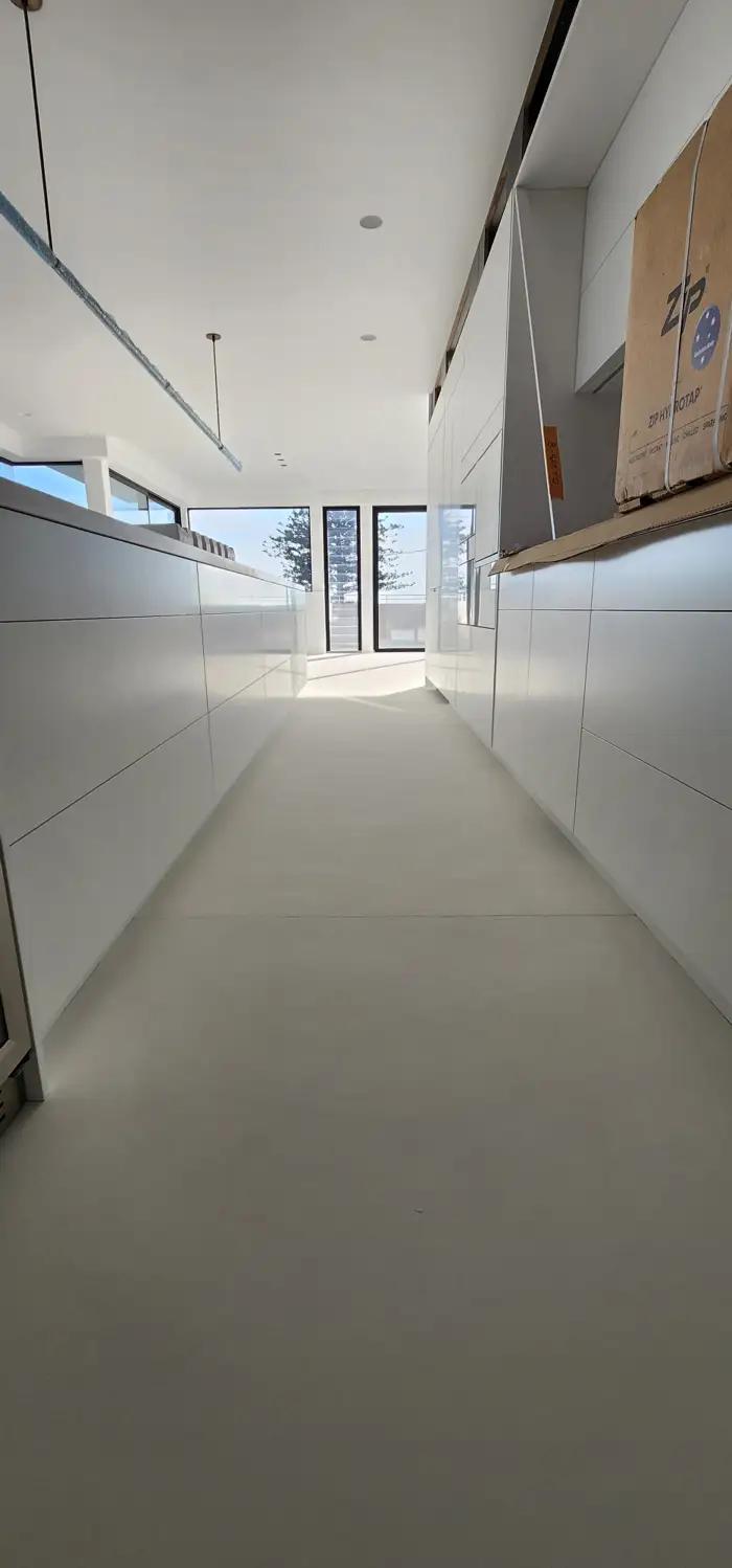 Continuous microcement floor flowing through an open-plan Avalon home