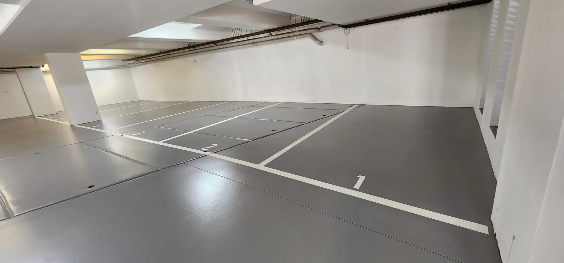 Completed plain-colour epoxy car park floor with line marking
