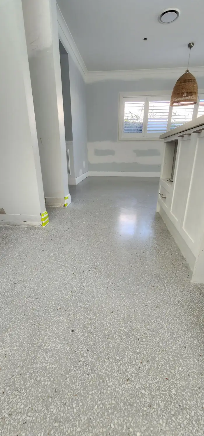 Seamless white terrazzo running wall-to-wall at Elumi Studio, Rosebery