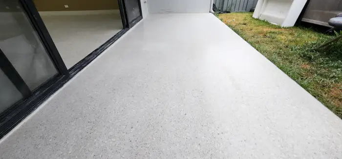 Poured terrazzo floor from hallway into open-plan living in a Kellyville home