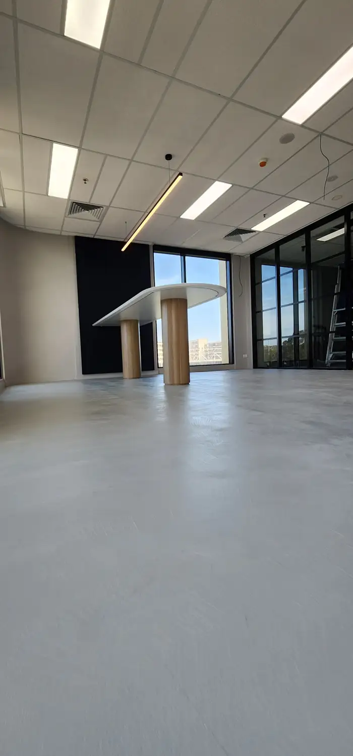 Floor-to-wall seamless microcement in a Woolooware commercial fit-out