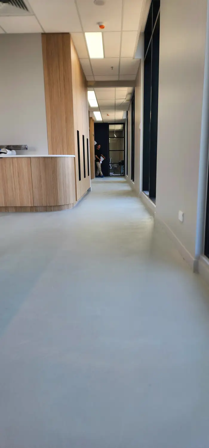 Floor-to-wall microcement in a Woolooware commercial interior